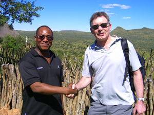 Ian Jackson shaking hands with the head of the Burkina Faso Geological Survey
